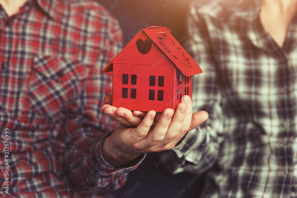 young loving couple holding in hands symbol of home and house young loving couple holding in hands symbol of home and house