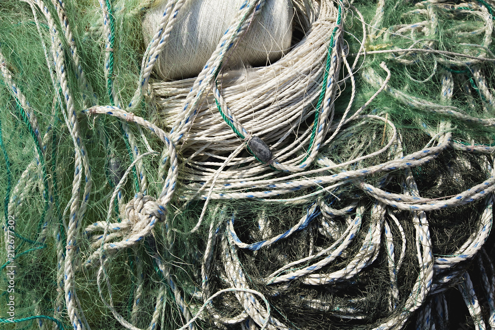 Closeup Old Boat Rope and Fishing Net Line Tangled Texture on a Dock Closeup Old Boat Rope and Fishing Net Line Tangled Texture on a Dock