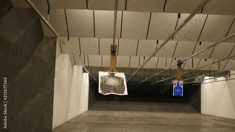 A Silhouette target at a gun range slides away from the camera 