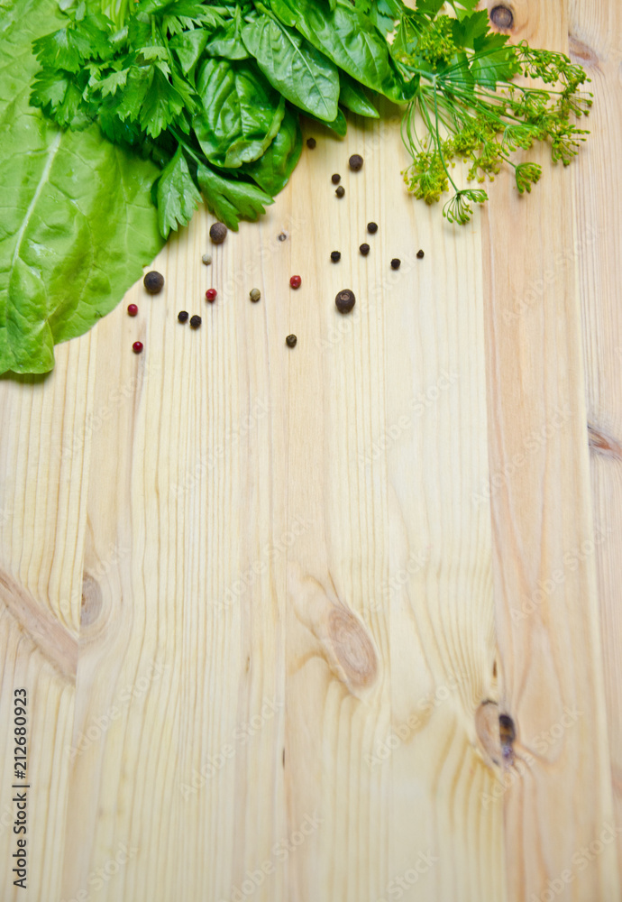 Basil and salad and dill next to pepper peas on wooden background Basil and salad and dill next to pepper peas on wooden background