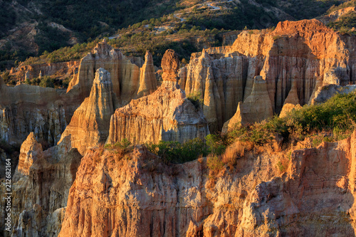 Earth Forest of Yuanmou in Yunnan Province, China - Exotic earth and sandstone formations glowing in the sunlight. Naturally formed pillars of rock and clay with unique erosion patterns. China Travel