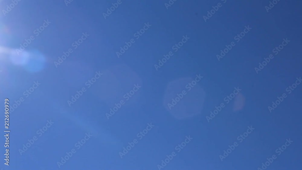 Pan of the sun with a blue sky background Pan of the sun with a blue sky background