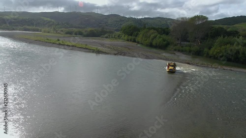 Earth work rock truck crossing a river with a load of rocks. photo