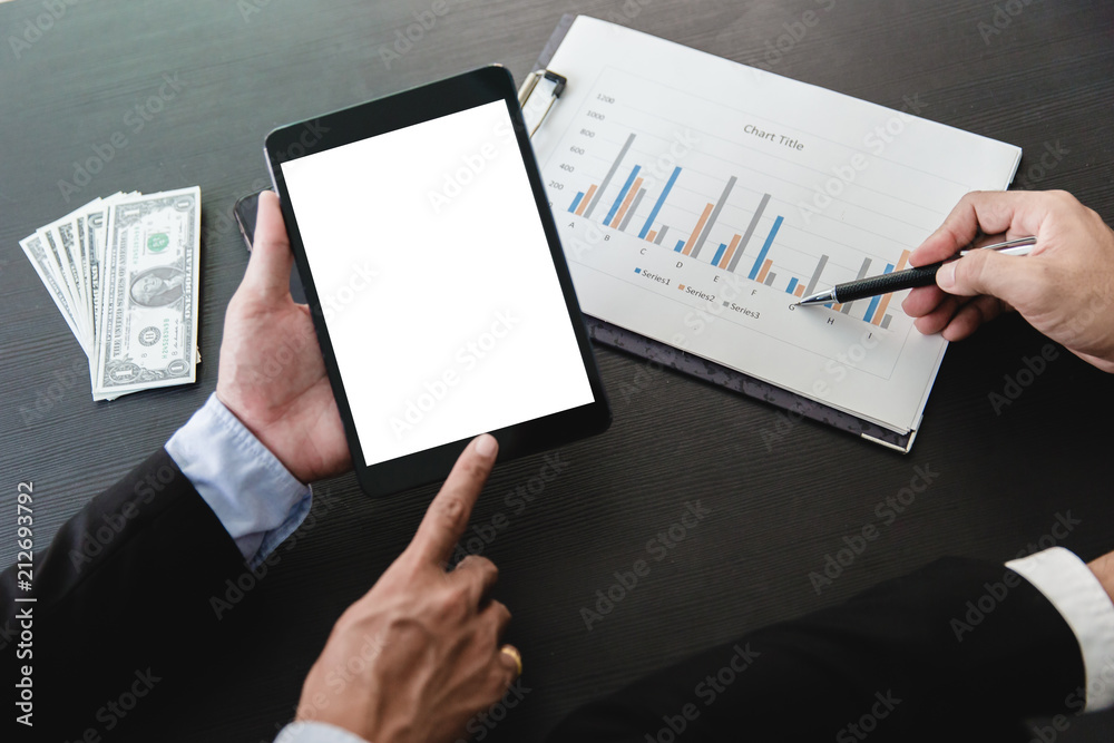 Close-up of business partners looking at business document in touchpad