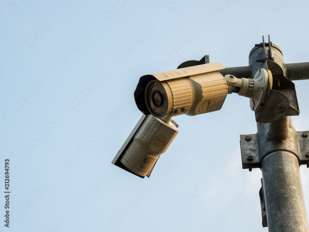 CCTV, Security Camera In The City On Blue Sky Background. CCTV, Security Camera In The City On Blue Sky Background.