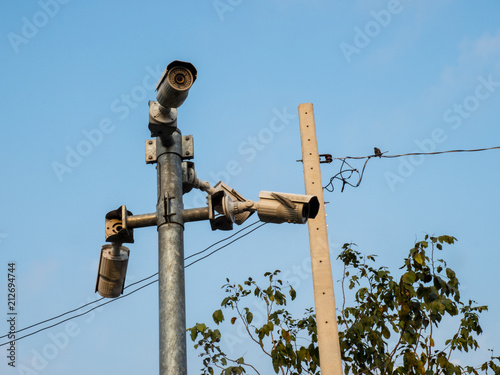 CCTV, Security Camera In The City On Blue Sky Background.