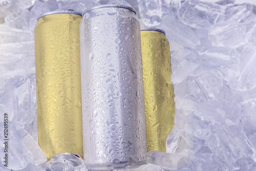 Aluminum beverage drink can in ice isolated on white background. Metal color silverand gold for your design.