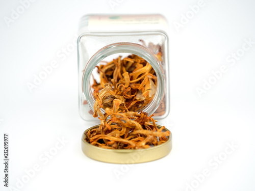 Healthy food Cordyceps Mushroom in a glass bottle dry for soup on white background. (selective focus)