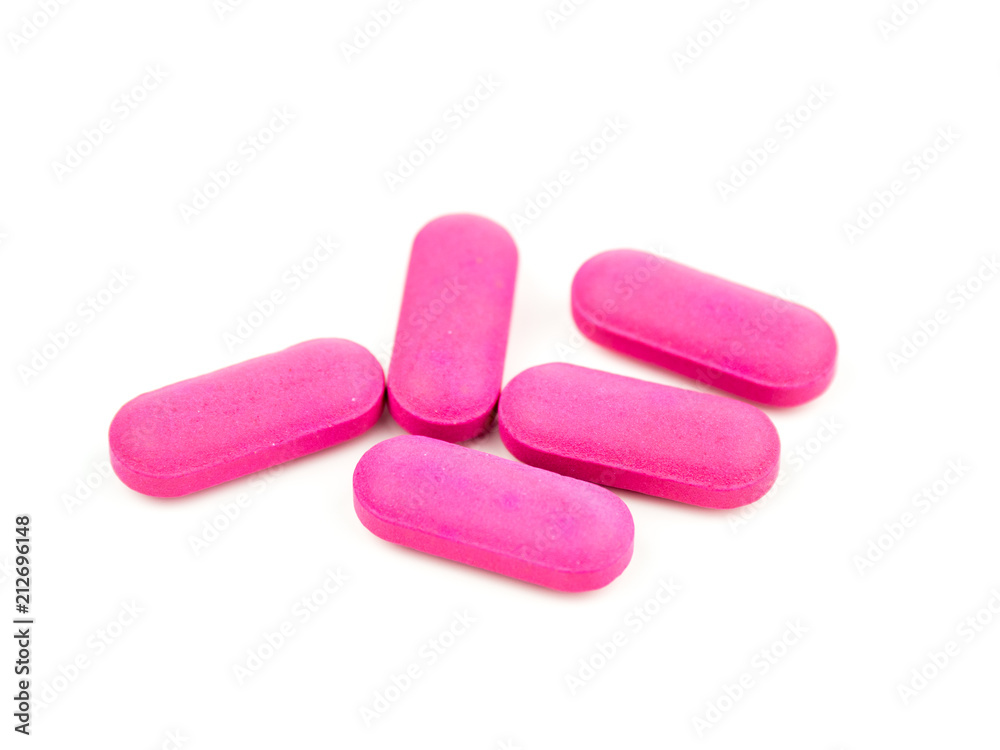 The pink pill is placed on a white background.