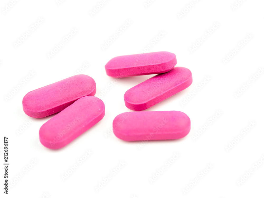 The pink pill is placed on a white background. The pink pill is placed on a white background.