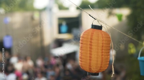 Lampion blowing in the wind with a crowd in the background at a festival during summer. Shot on the A7SII in 50fps. photo