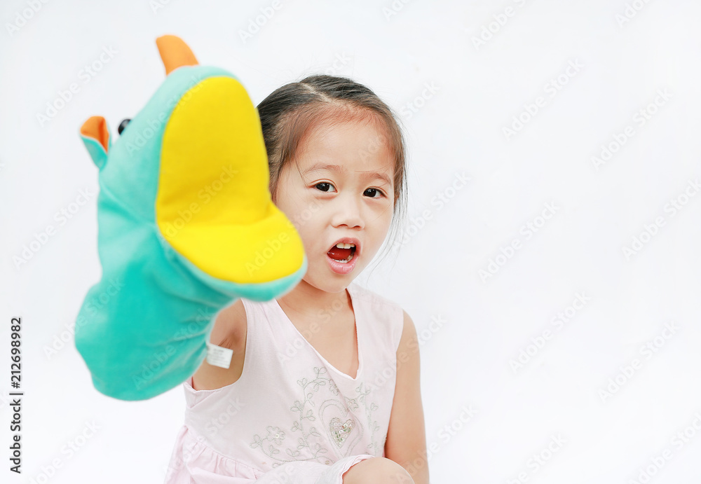 Little Asian child girl hand wear and playing Rhinoceros puppets on white background. Little Asian child girl hand wear and playing Rhinoceros puppets on white background.