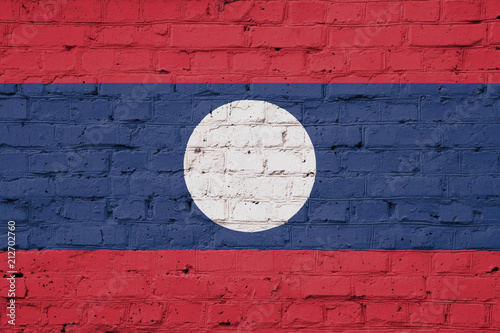 Texture of a flag of Laos on a pink brick wall.