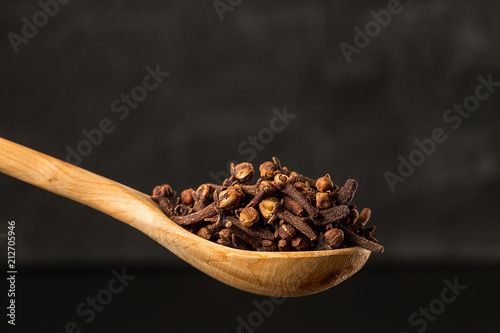 cloves  seasoning in a wooden spoon close up photo