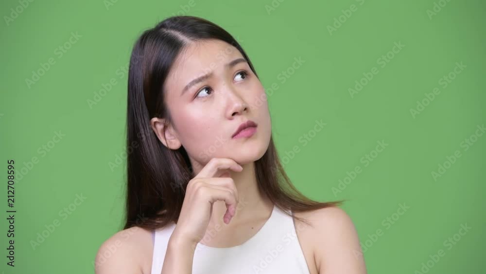 Young beautiful Asian businesswoman thinking Young beautiful Asian businesswoman thinking