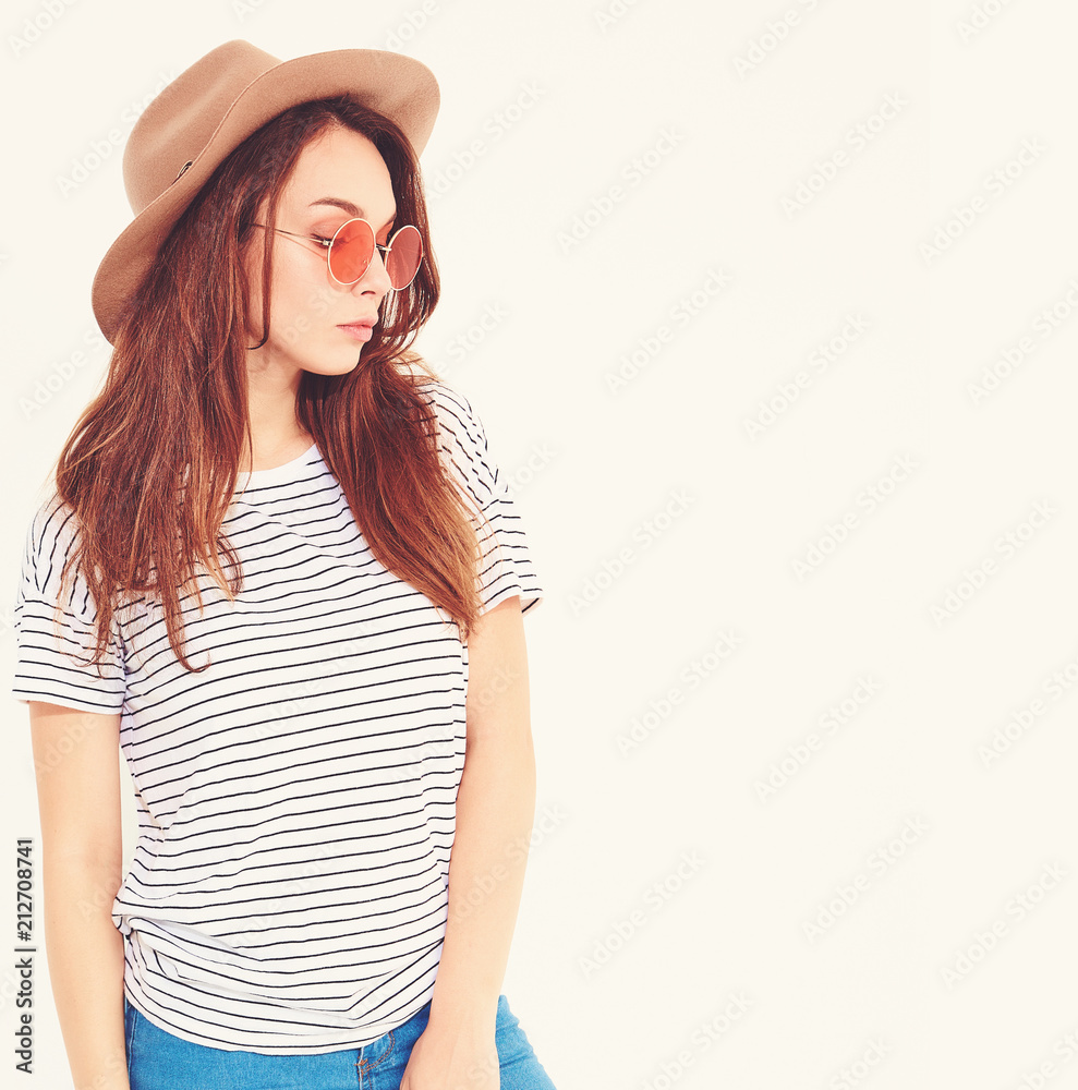Portrait of young stylish laughing girl model in casual summer clothes in brown hat with natural makeup isolated on white background. In sunglasses. Portrait of young stylish laughing girl model in casual summer clothes in brown hat with natural makeup isolated on white background. In sunglasses.