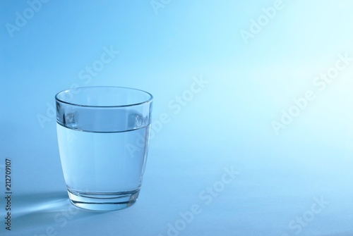 Glass of water in blue