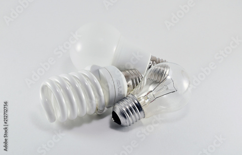 Three different types of light bulbs of different shapes on white background