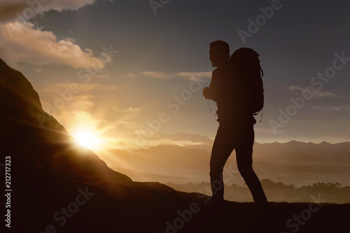 Silhouette of backpacker man hiking the mountain