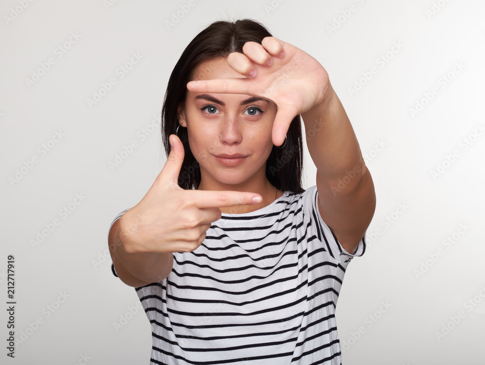 Young woman taking picture with imaginary camera Young woman taking picture with imaginary camera