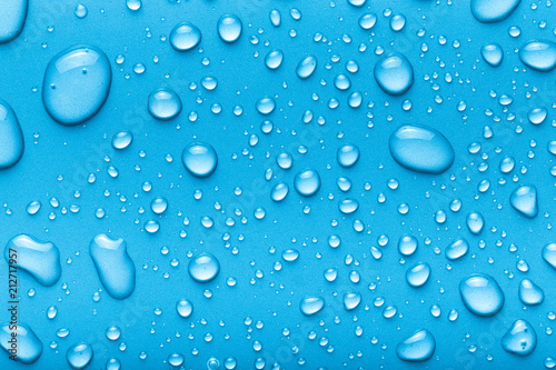 Drops of water on a color background. Blue. Toned
