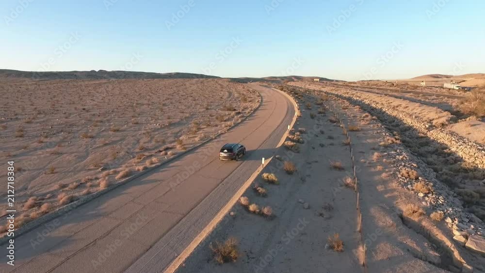 Flight over long highway at monument valley in Utah - Drone Aerial over cars in Arizona. Top view drone footage flying over dry and beige desert, drought resulted landscape, global warming threat Flight over long highway at monument valley in Utah - Drone Aerial over cars in Arizona. Top view drone footage flying over dry and beige desert, drought resulted landscape, global warming threat