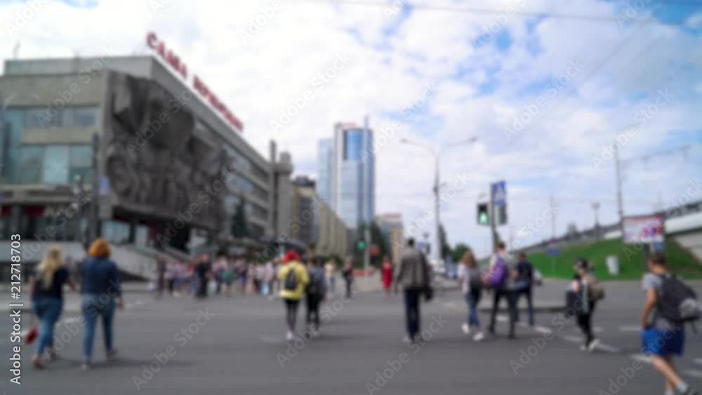 Blurred view of people walking along the street, people cross the road, blurred background.
Blurred view of people walking along the street, people cross the road, blurred background.