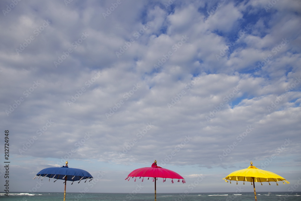 Three colorful umbrellas on the beach in Bali,Indonesia
