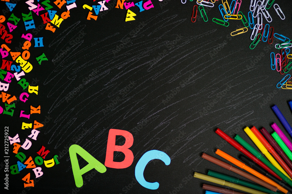 Back to school background. Top view of school supplies on chalkboard. Back to school background. Top view of school supplies on chalkboard.