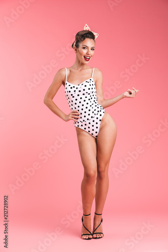Photography Full length portrait of a smiling brunette pin-up girl