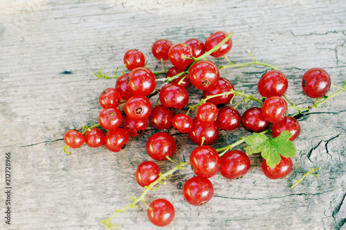 Red currant on wooden background. Summer berry