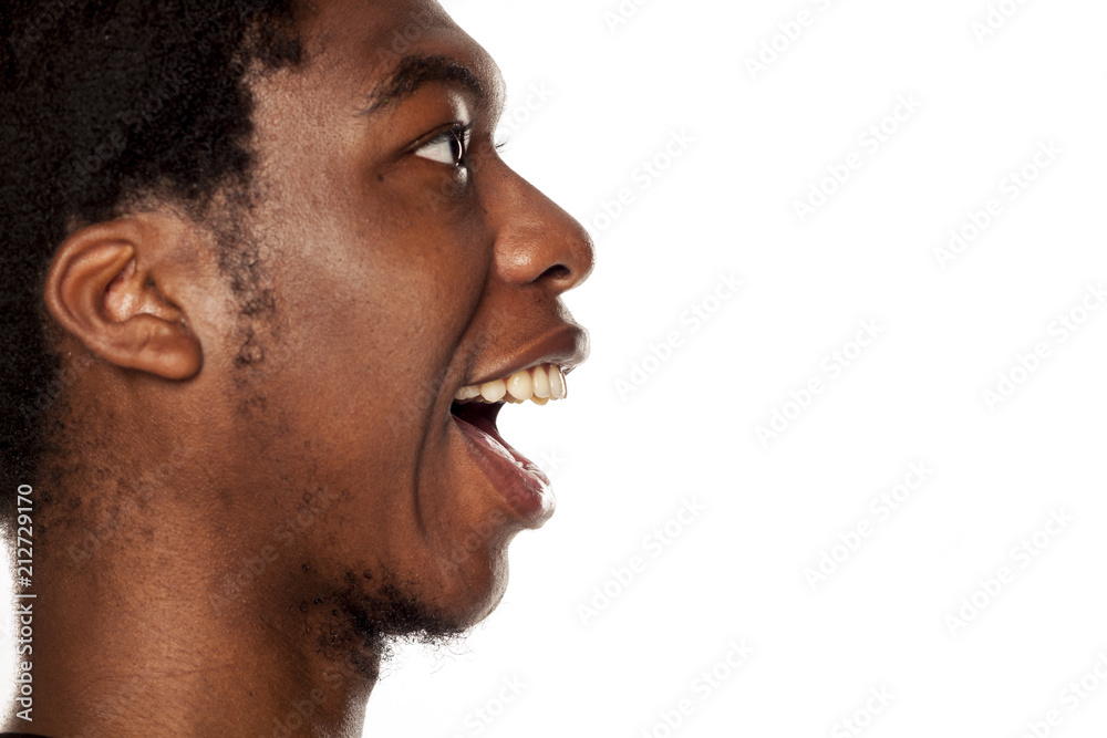 Obraz premium Profile of young happy black african american guy on white background