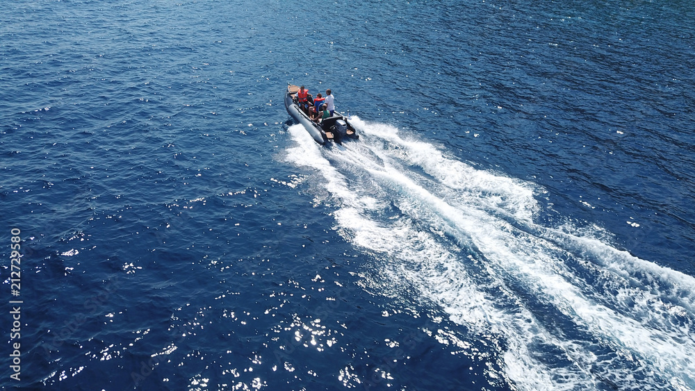 Obraz premium Aerial bird's eye view of inflatable rib boat cruising in high speed in deep blue mediterranean sea