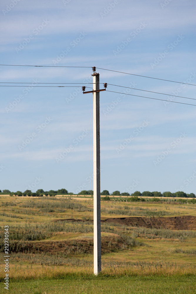 Electric power lines on the background of the field and blue sky. Electric power lines on the background of the field and blue sky.