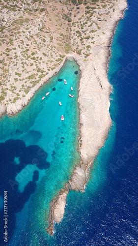 Aerial photo of tropical rocky seascape with beutiful turquoise clear sea and boats docked