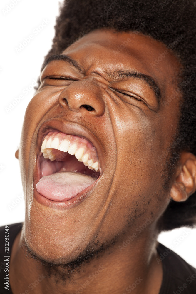 Very happy african american young man with funny face on white background  Stock Photo | Adobe Stock