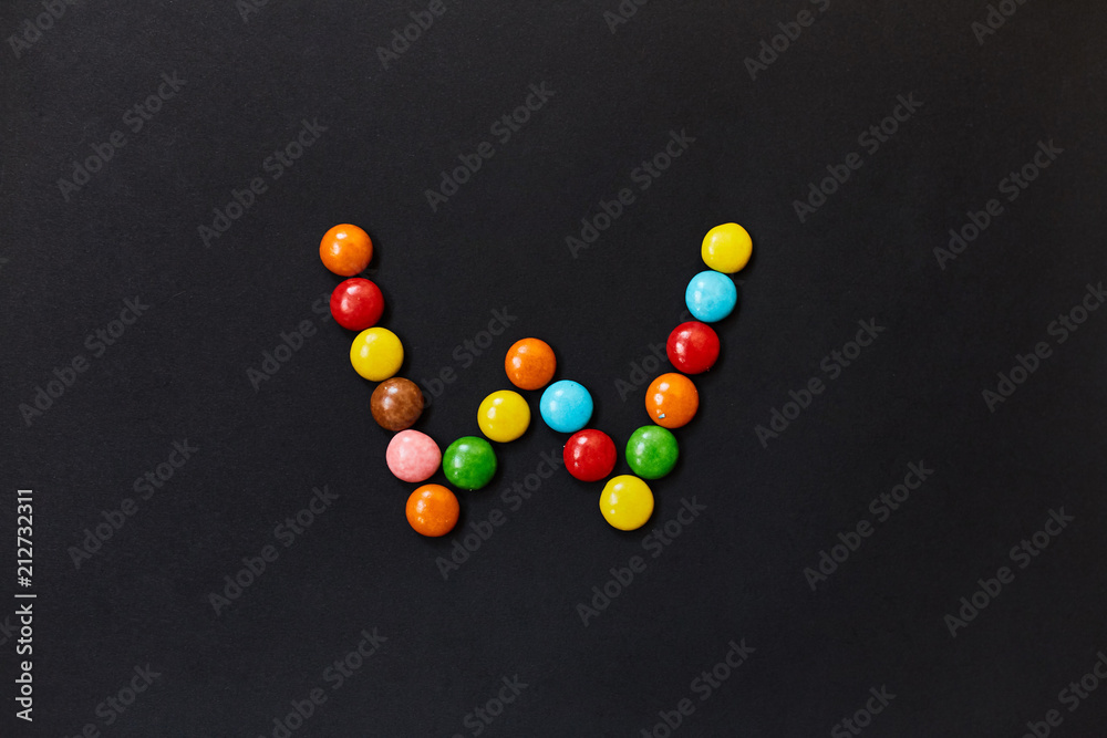 English Alphabet made of colored candies. The letter W. English Alphabet made of colored candies. The letter W.
