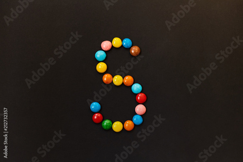 English Alphabet made of colored candies. The letter S.