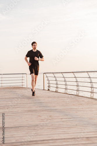 Handsome young sportsman running © Drobot Dean