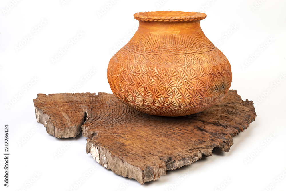 clay pot with traditional pattern on old wood