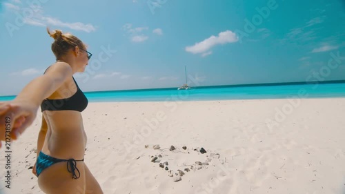 POV holding hands with girl in bikini on beach, Klein Curacao photo