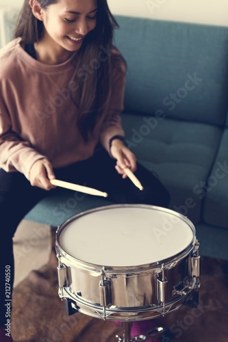 White woman playing drum