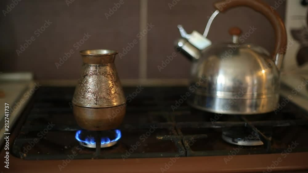 making coffee in the Turkish coffee pot on a gas stove. food and drink at home. making coffee in the Turkish coffee pot on a gas stove. food and drink at home.