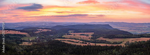 Sunset panorama, inspiring landscape, green forest and mountains