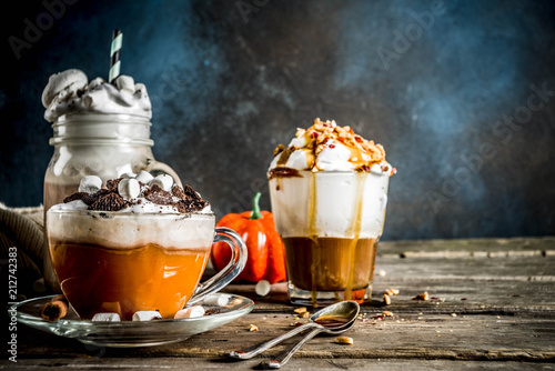 Autumn winter warm drinks, hot chocolate, pumpkin latte, caramel and peanut coffee latte, mulled wine, cozy dark background copy space