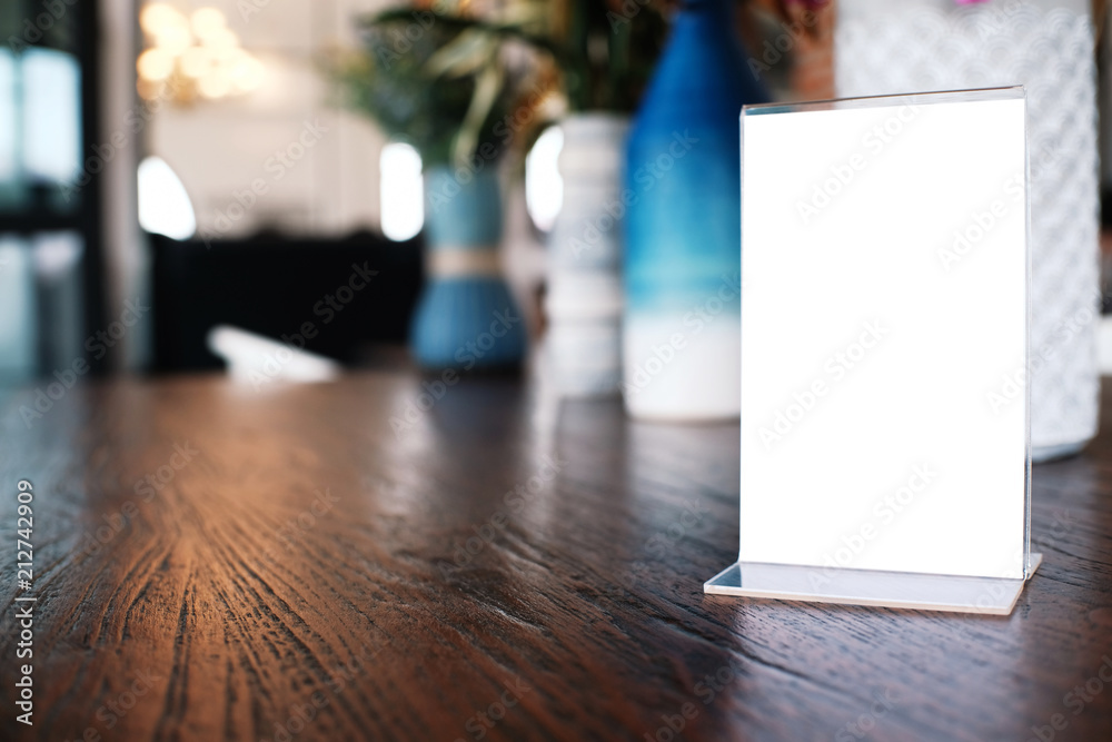 Menu frame standing on wood table in Bar restaurant cafe. space for text marketing promotion. Menu frame standing on wood table in Bar restaurant cafe. space for text marketing promotion.