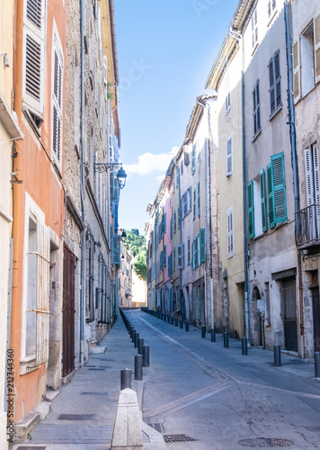 colorful houses on narrow street Grande Rue in Draguignan, Cote d'Azur, France on sunny summer day © Christian Horz