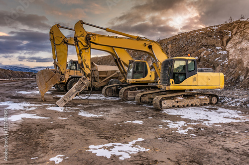 Фотография Heavy machinery in a hard day of work in the construction of a road