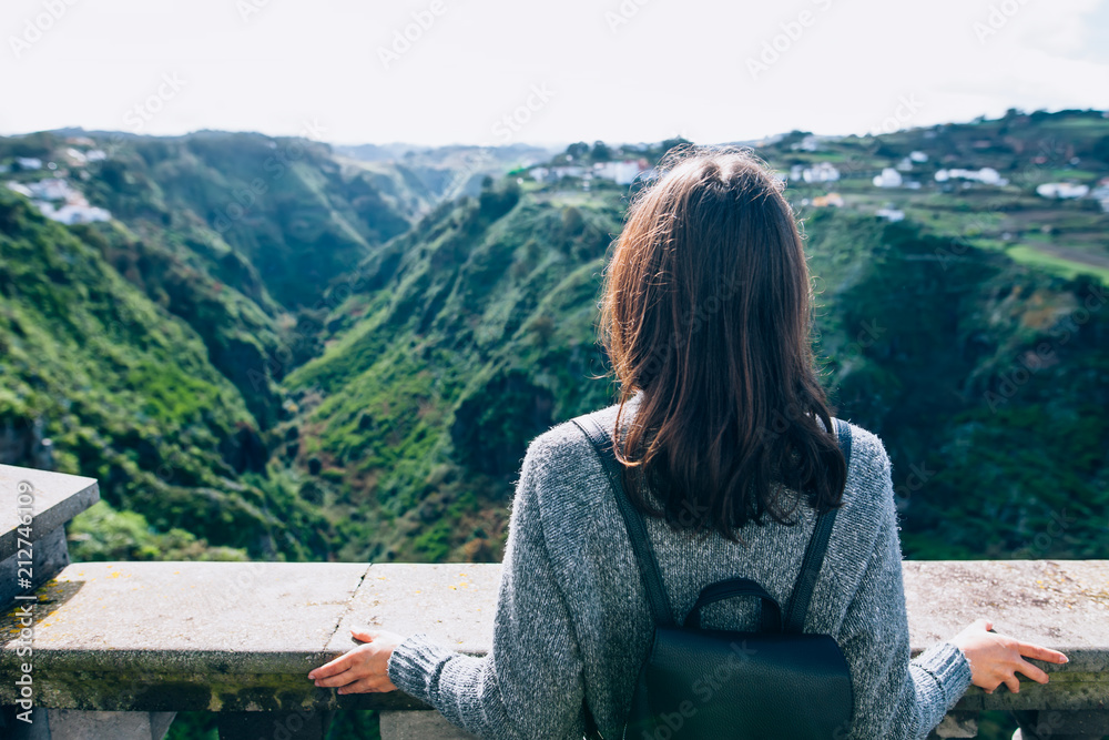 Back view of traveler woman enjoying beautiful green canyon on Gran Canaria