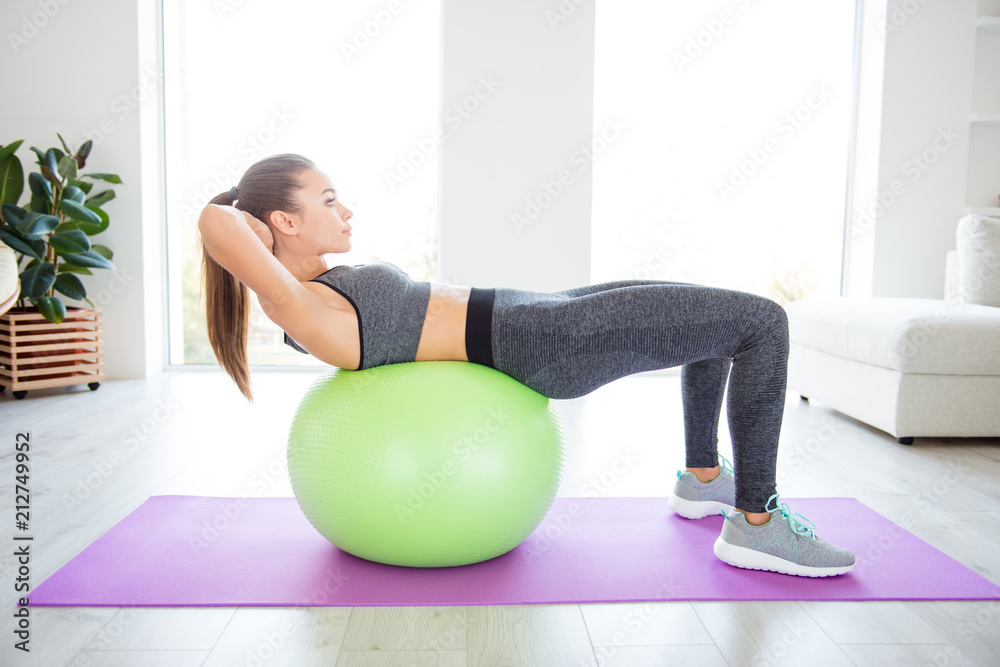 Vitality wellness healthy lifestyle gym club group people person model concept. Side profile full-length view photo portrait of sporty sportive beautiful purposeful determined girl doing sit-ups